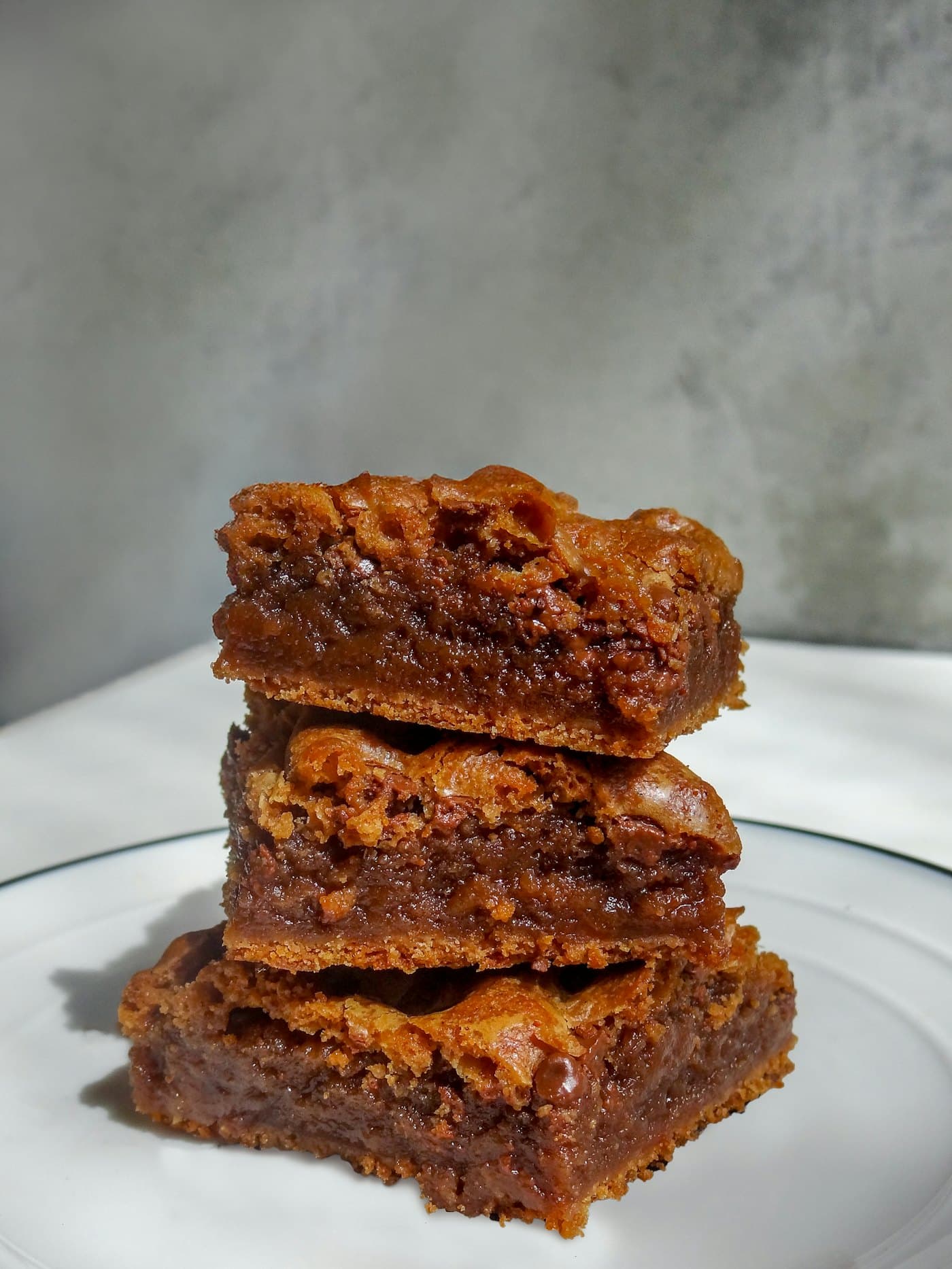 A stack of golden blondies on a white plate