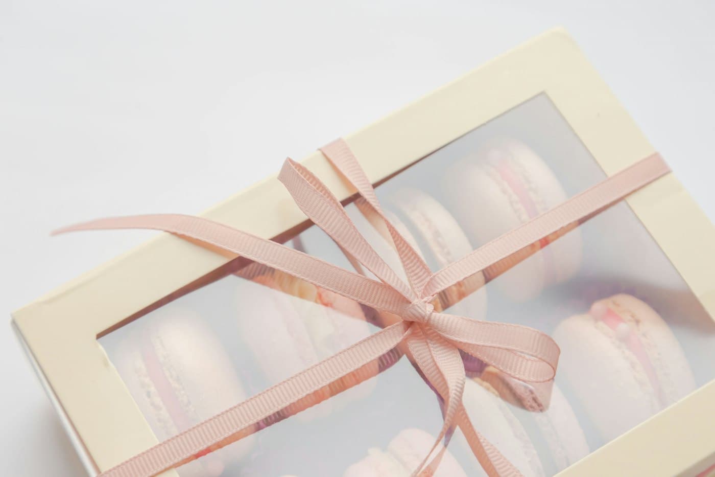 A treat box wrapped with a pale pink ribbon