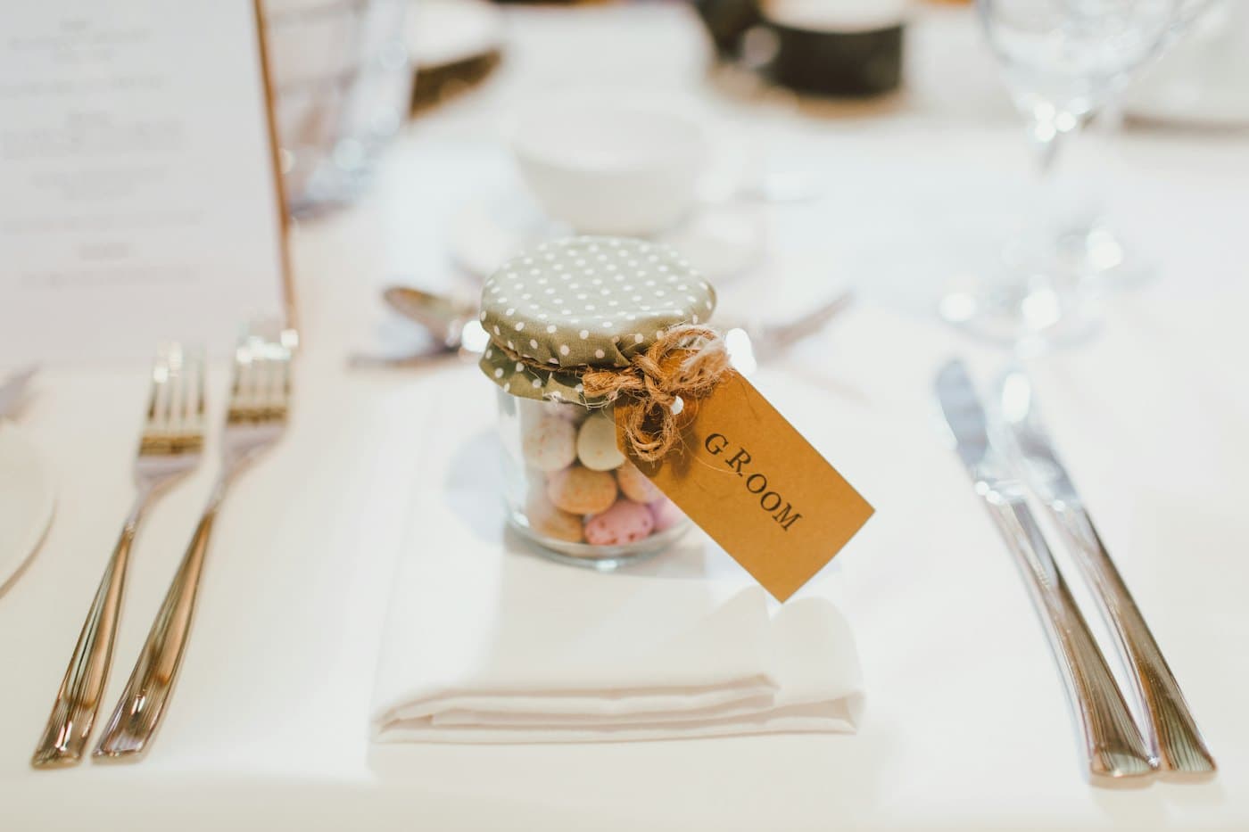 A wedding favour with a handwritten tag at a place setting